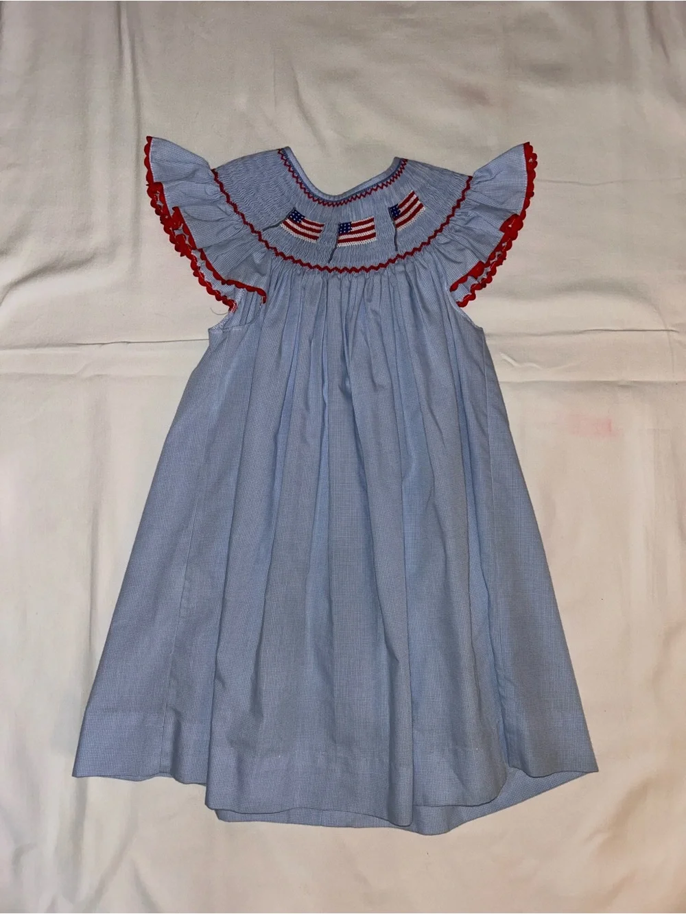 Girls' Light Blue Smocked Dress with Red Trim and Flag Embroidery